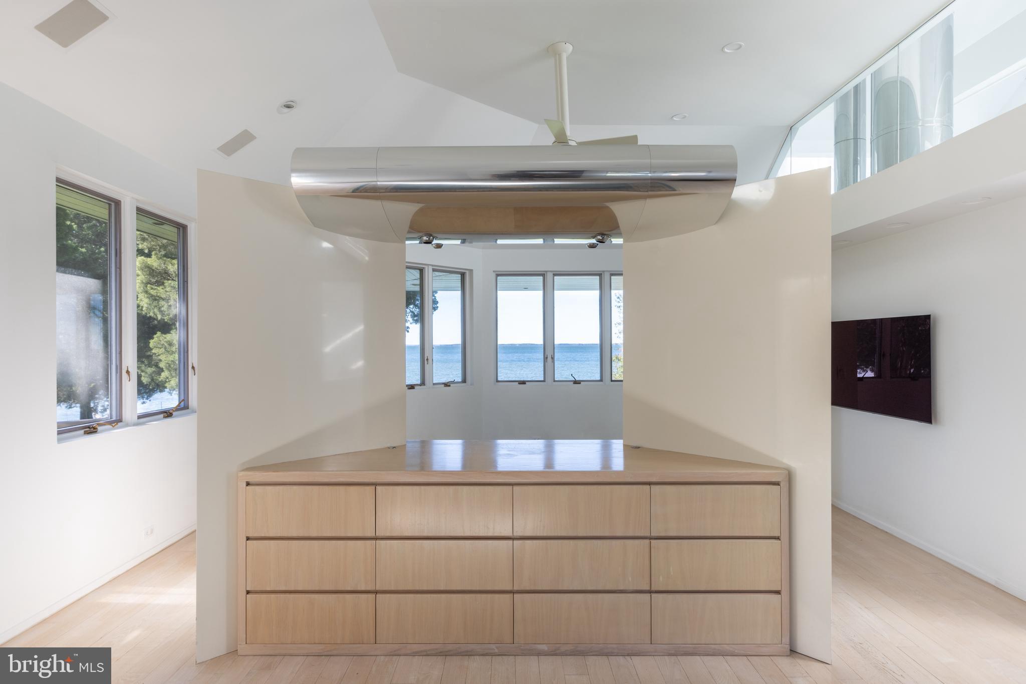 5084 Ferry Neck Road Royal Oak, MD 21662 - Photo 33 of 58 a room with a chandelier and wooden floor