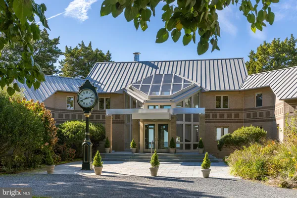 a front view of a building with a garden