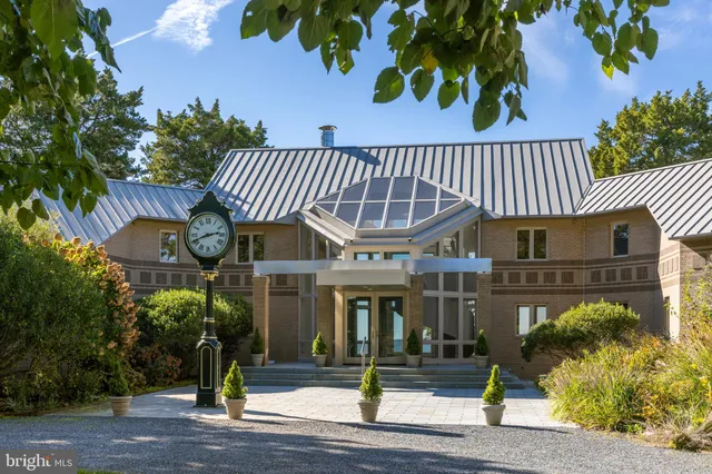 a front view of a building with a garden