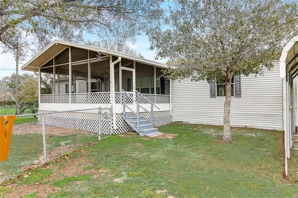 4606 Cooper Road Plant City, FL 33565 - Photo 1 of 1 a front view of a house with garden