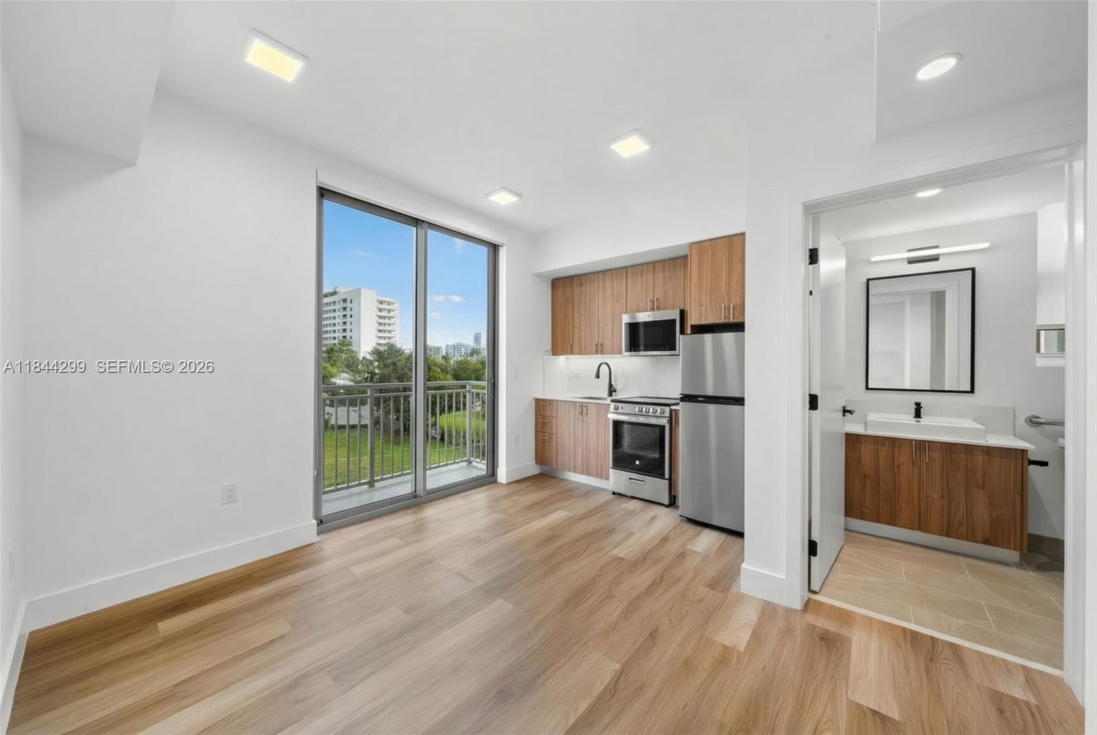 a open kitchen with white cabinets and stainless steel appliances