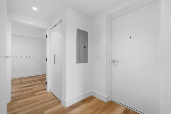 a view of a hallway with wooden floor