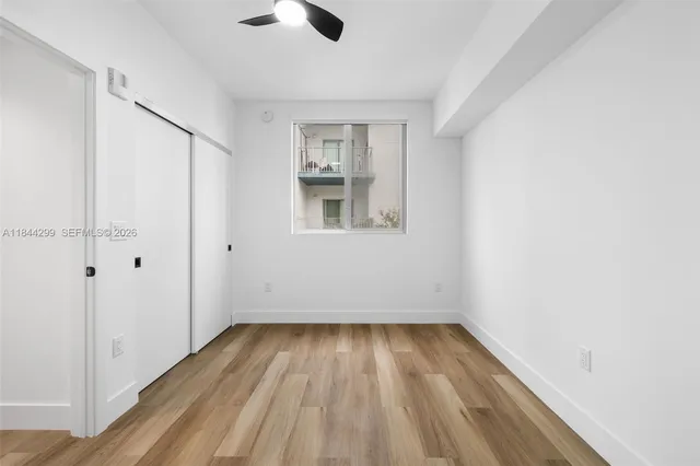 wooden floor in an empty room with a window