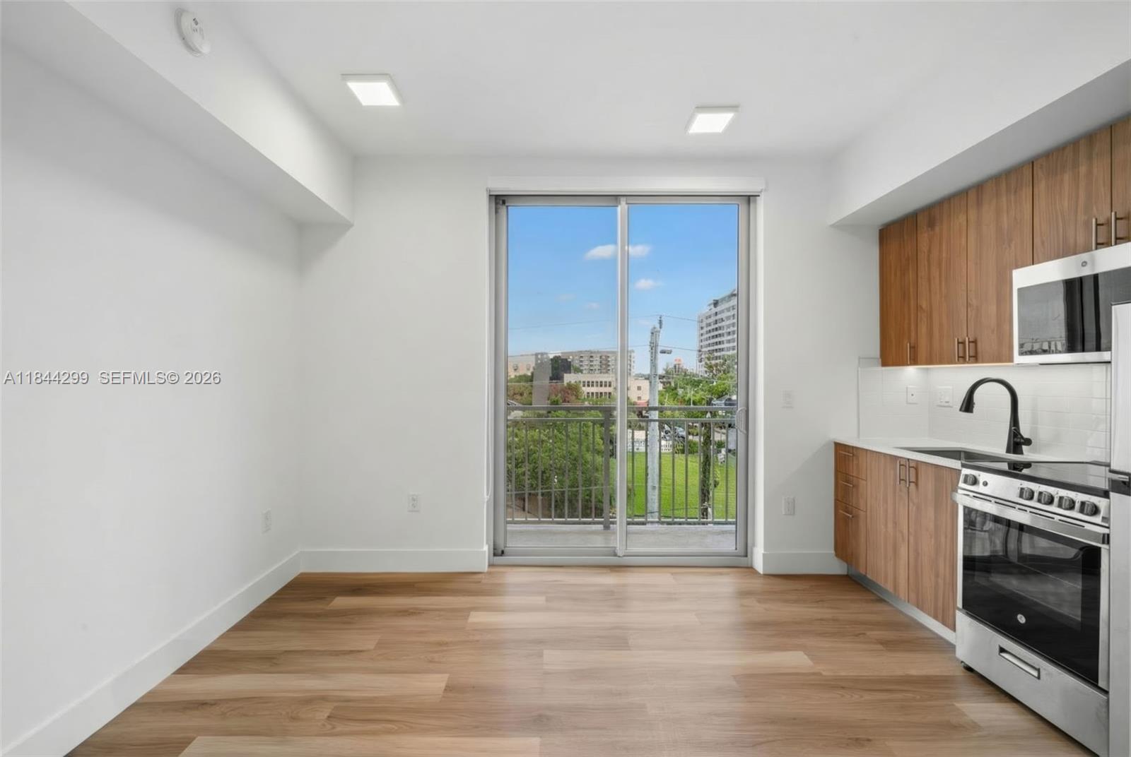 650 Southwest 1st Street, Unit 206 Miami, FL 33130 - Photo 3 of 22 a view of a kitchen with a sink and a fireplace