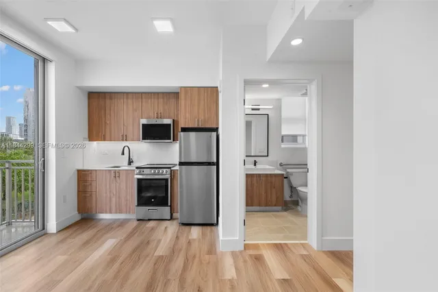 a view of kitchen and wooden floor