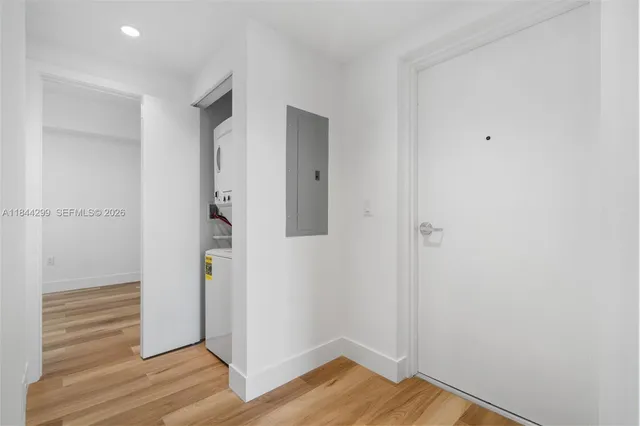 a view of a hallway with wooden floor