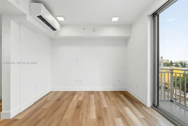 a view of a room with wooden floor and city view
