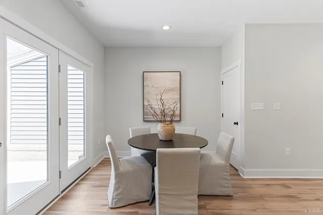 a dining room with furniture and wooden floor