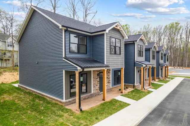 a view of a white house with iron fence