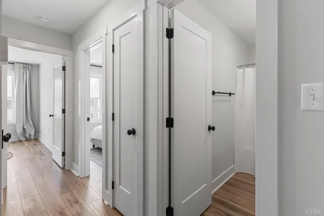 a view of a hallway with wooden floor
