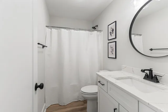 a bathroom with a sink toilet and a mirror