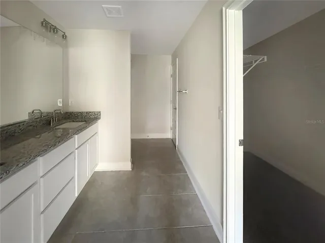a hallway with granite countertop a sink and dishwasher