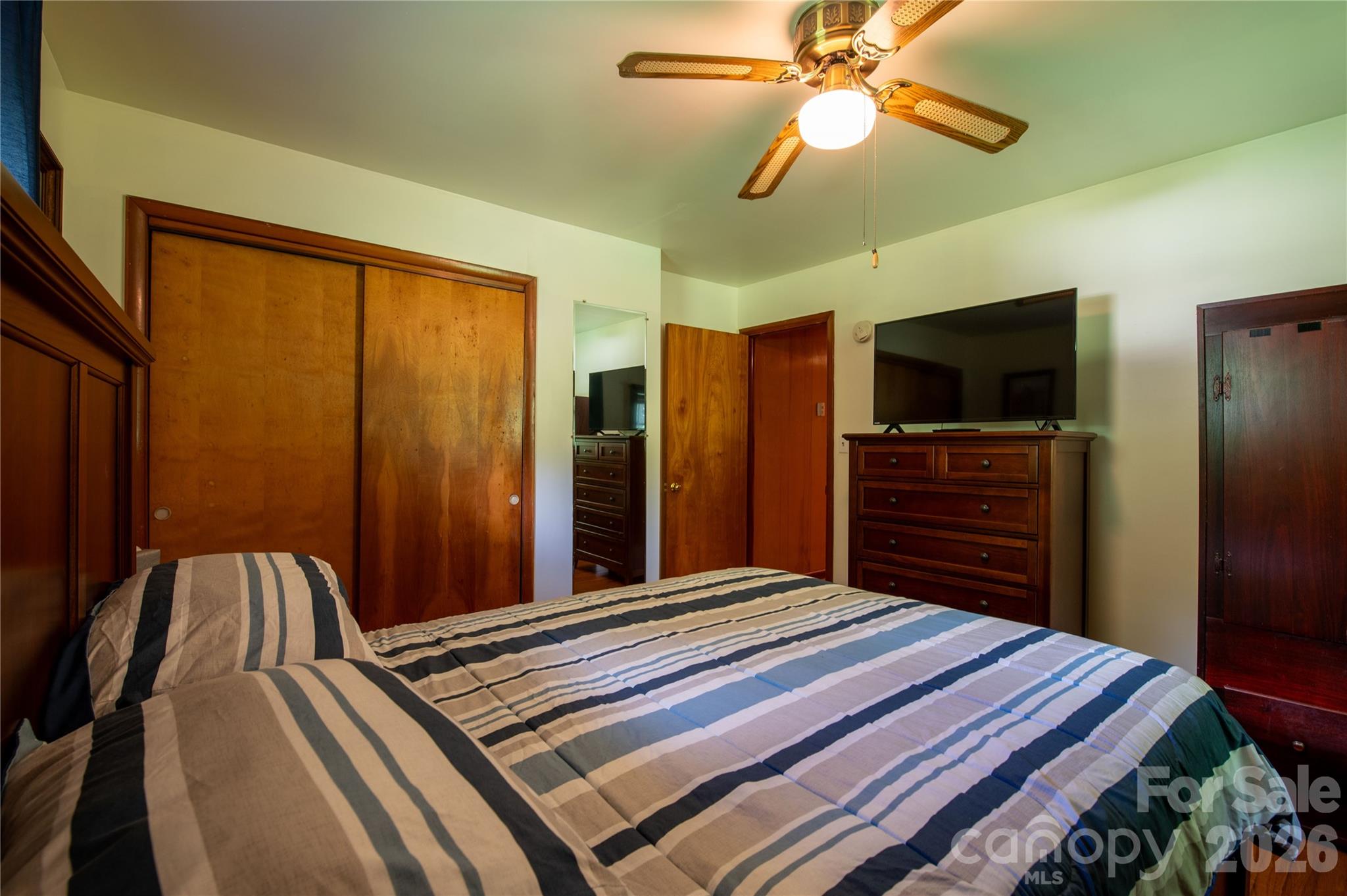 40 Double Island Road Burnsville, NC 28714 - Photo 25 of 38 a bedroom with a bed and a flat screen tv