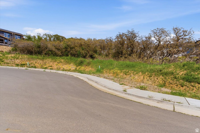 5102 Sunset Way, Unit 404 Ogden, UT 84403 - Photo 2 of 13 View of asphalt street featuring curbs and sidewalks