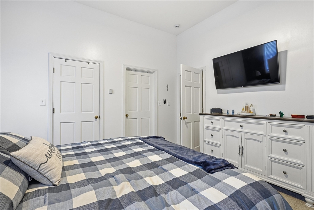 52 Church Street Gardner, MA 01440 - Photo 15 of 36 a bedroom with a bed and a flat screen tv
