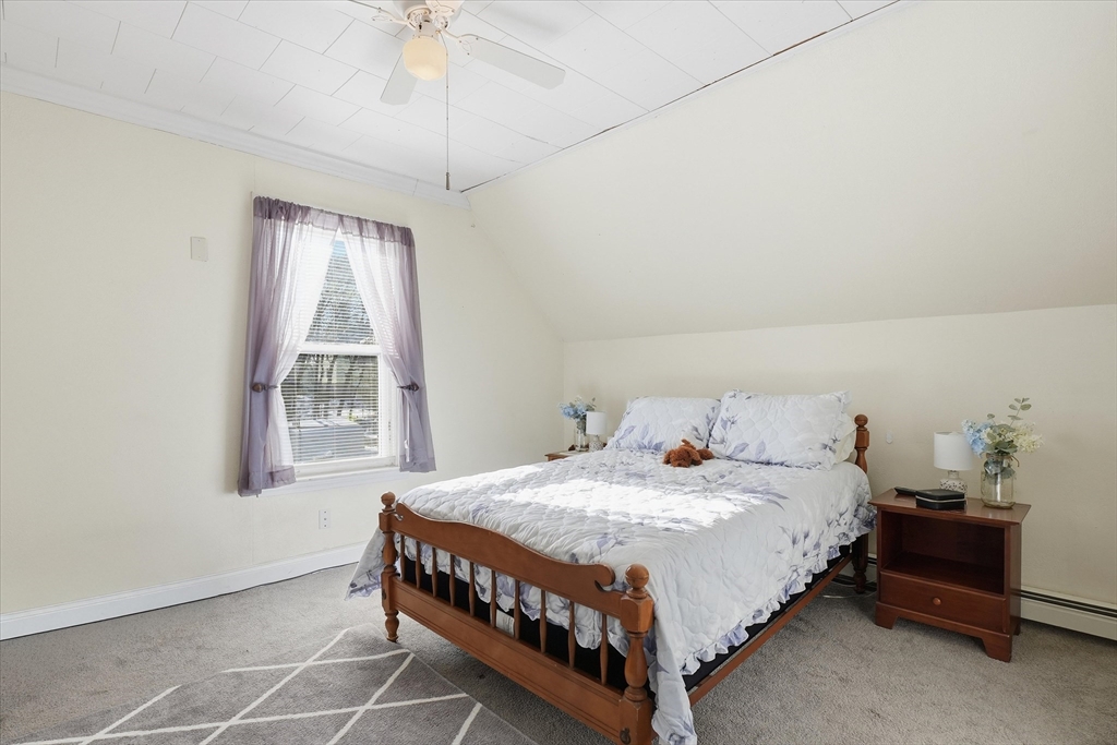 52 Church Street Gardner, MA 01440 - Photo 18 of 36 a bedroom with a bed lamp and a window