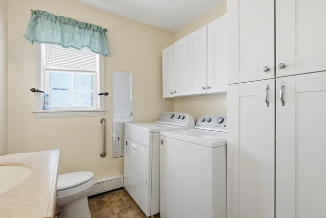 a view of bathroom with a toilet sink and a mirror