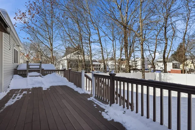 a view of a patio with wooden fence and a bench