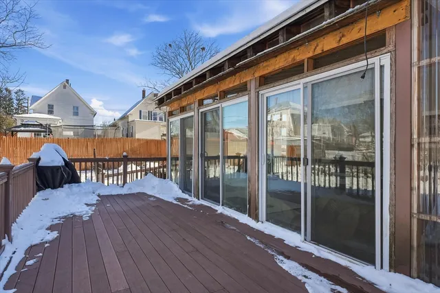 a balcony of a house with wooden floor and outdoor space