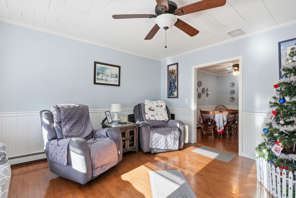 52 Church Street Gardner, MA 01440 - Photo 5 of 36 a living room with furniture potted plant and a chandelier