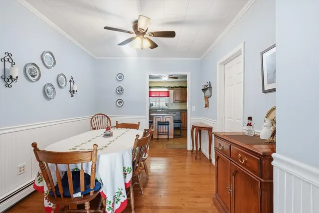 a very nice looking dining room with kitchen island a stove a sink a dining table and chairs
