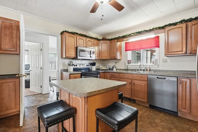 a kitchen with stainless steel appliances granite countertop a stove a sink dishwasher and a refrigerator