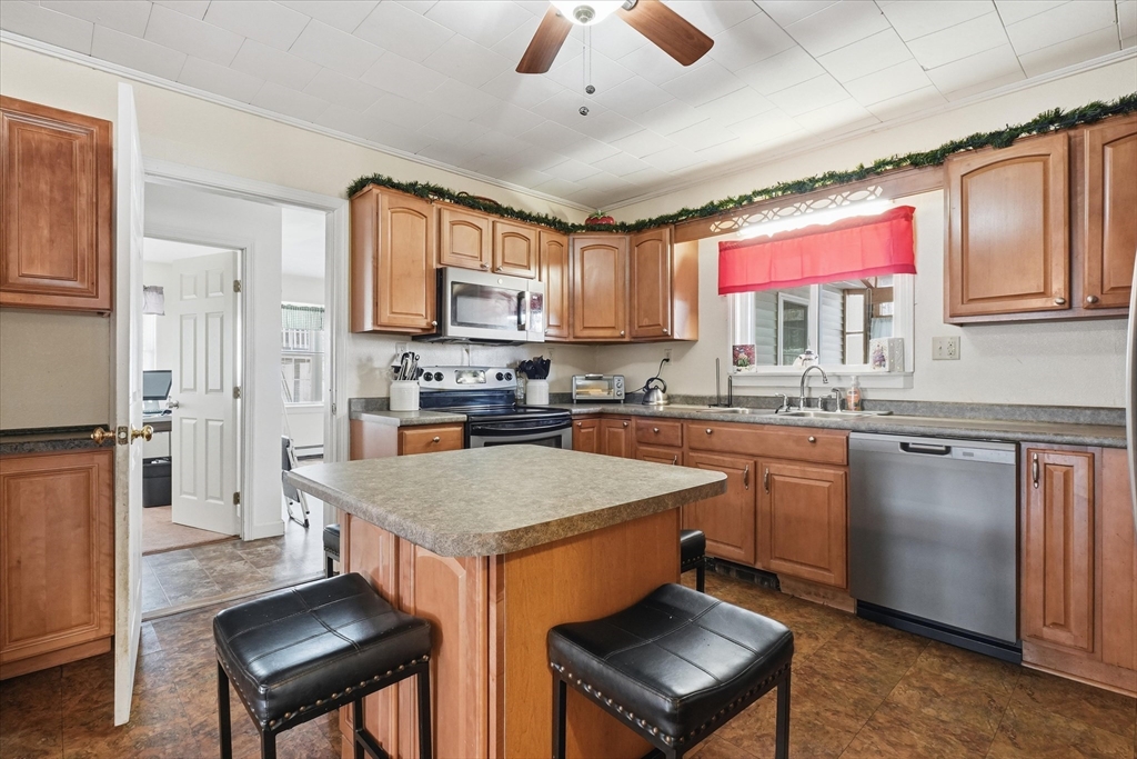 52 Church Street Gardner, MA 01440 - Photo 9 of 36 a kitchen with stainless steel appliances granite countertop a stove a sink dishwasher and a refrigerator