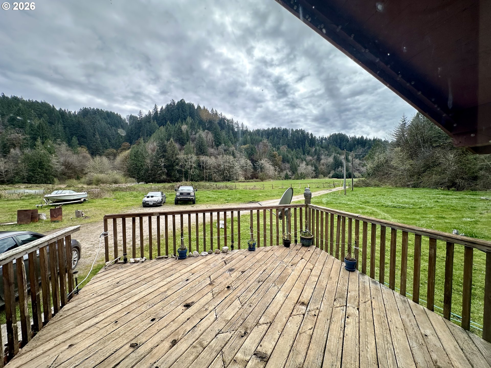 1910 Otter Slough Road Reedsport, OR 97467 - Photo 11 of 39 a view of a wooden deck with a yard