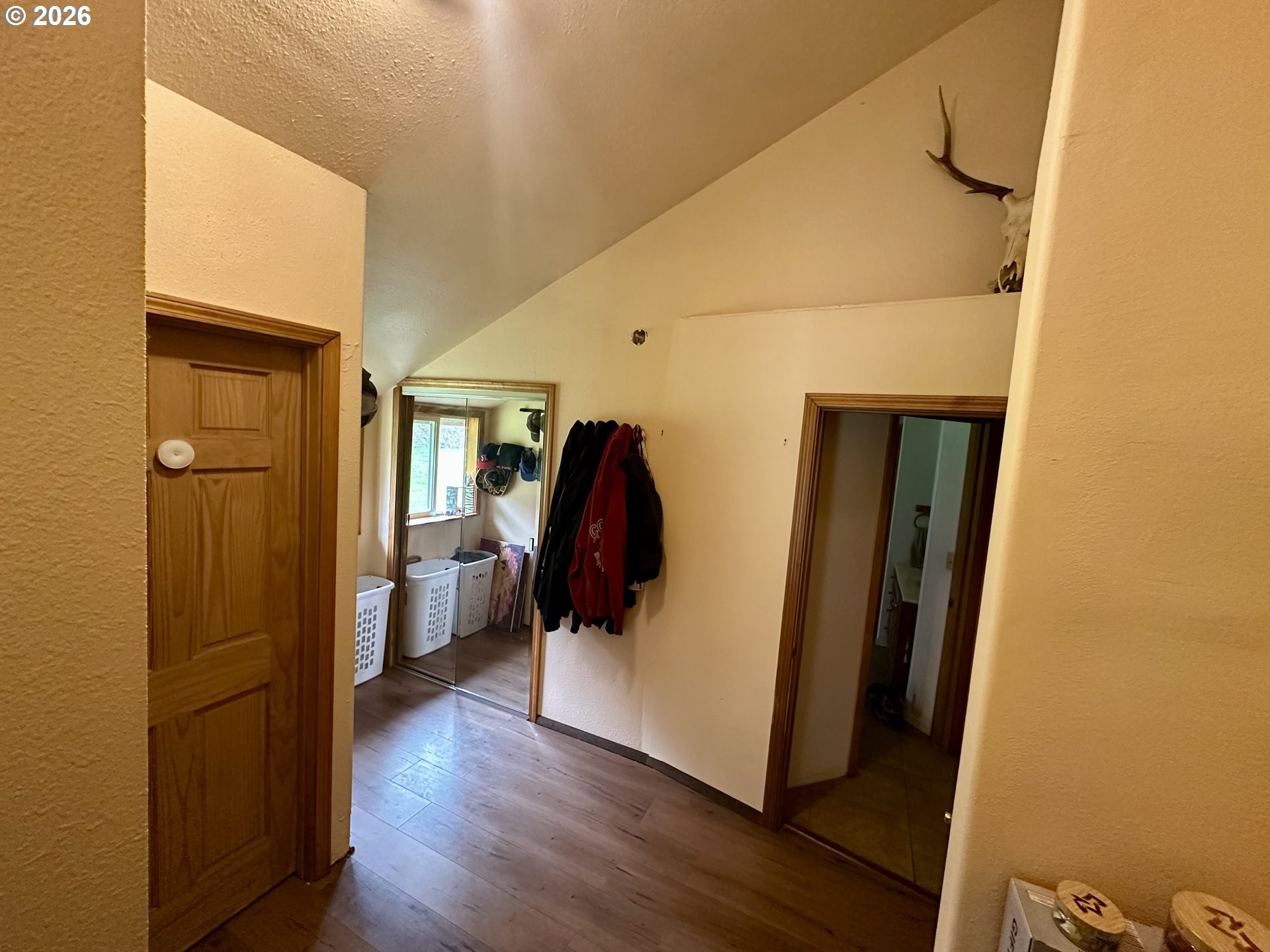 1910 Otter Slough Road Reedsport, OR 97467 - Photo 12 of 39 a view of a hallway with wooden floor and furniture