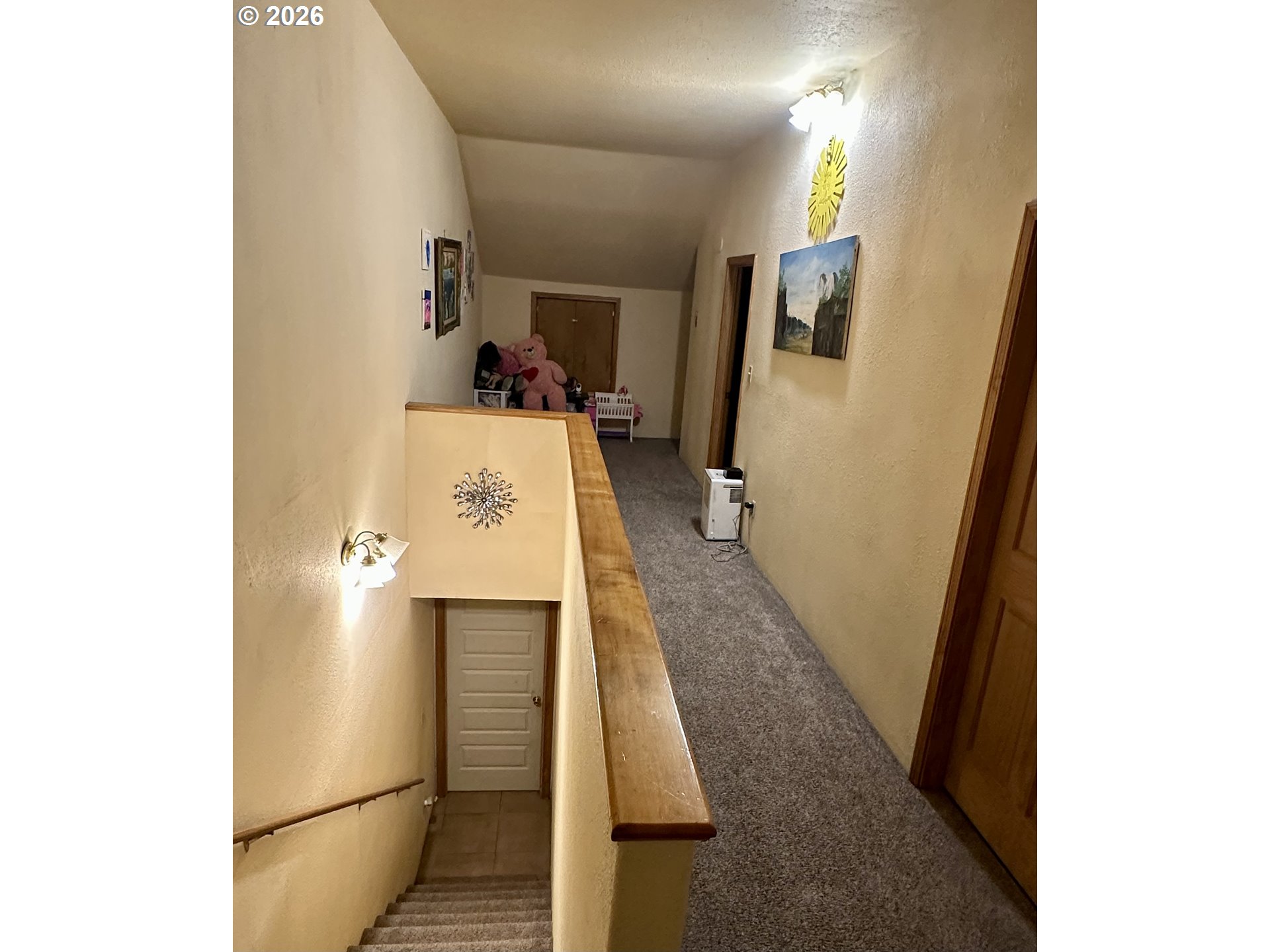 1910 Otter Slough Road Reedsport, OR 97467 - Photo 16 of 39 a hallway with a large refrigerator in kitchen and sink