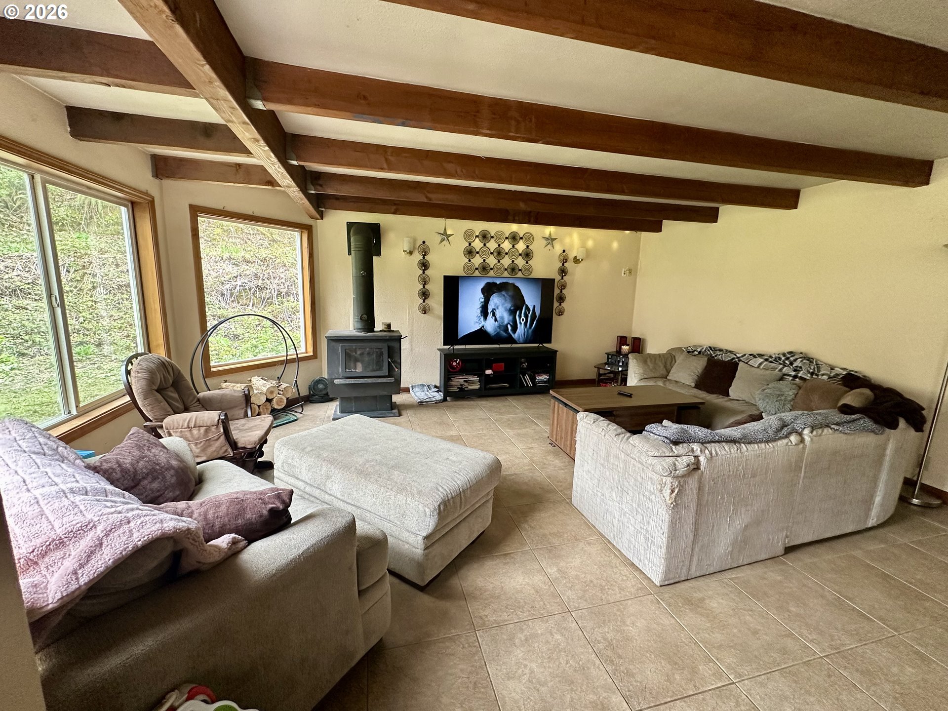 1910 Otter Slough Road Reedsport, OR 97467 - Photo 2 of 39 a living room with furniture and a large window