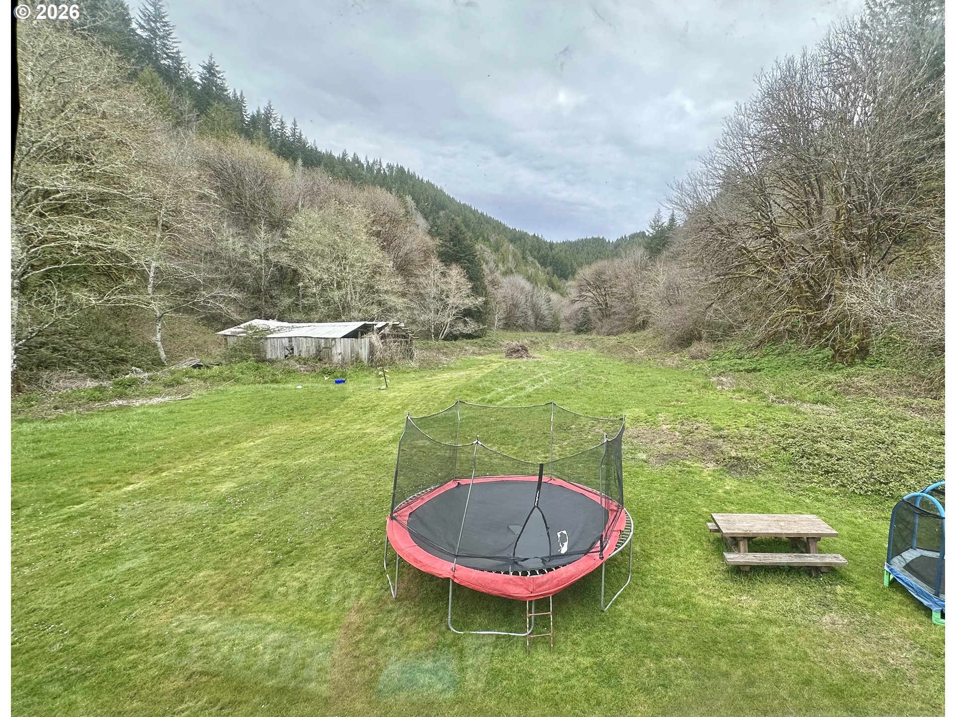 1910 Otter Slough Road Reedsport, OR 97467 - Photo 26 of 39 a backyard of a house with table and chairs