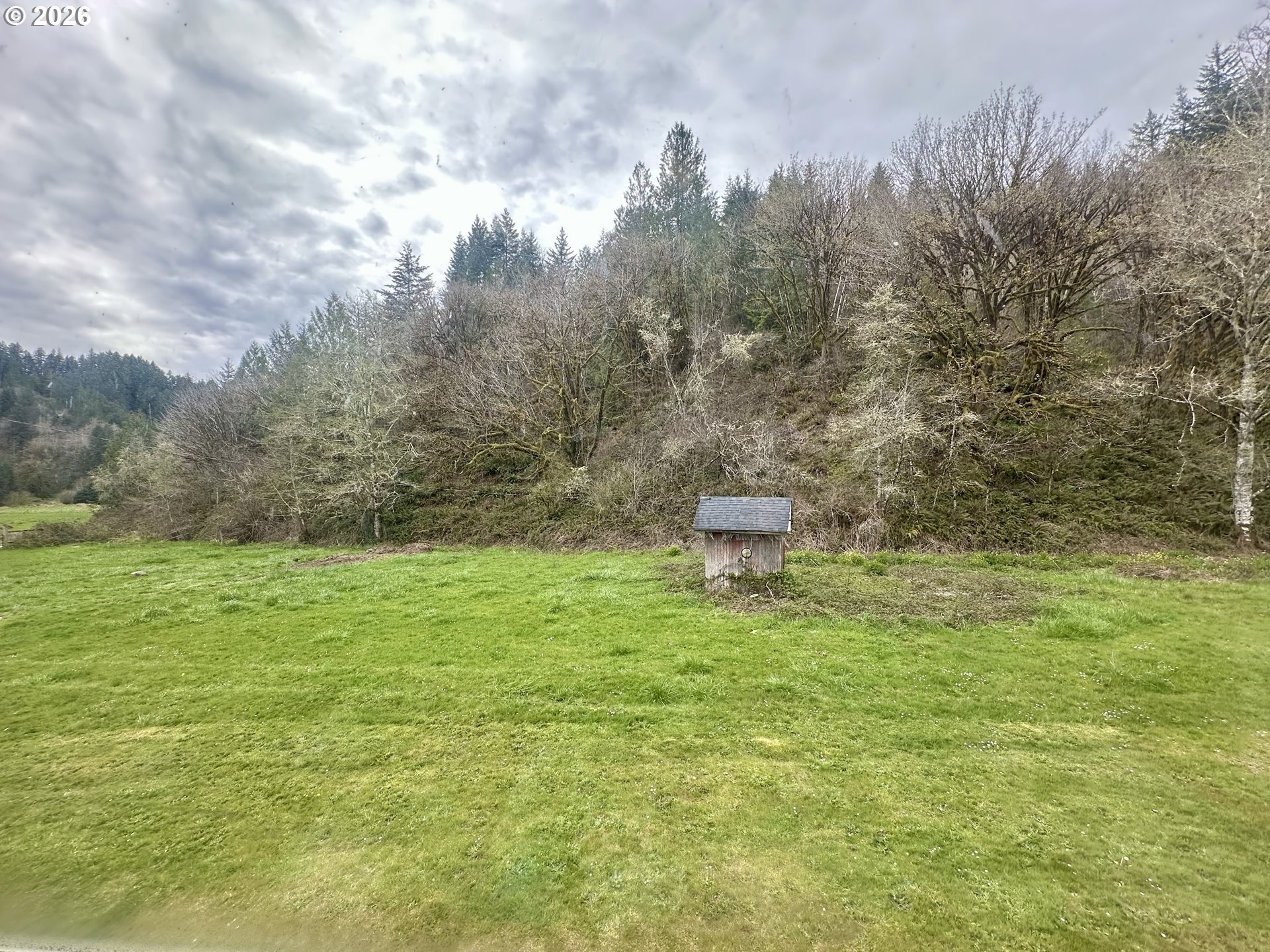 1910 Otter Slough Road Reedsport, OR 97467 - Photo 28 of 39 a backyard of a house with lots of green space and tiles