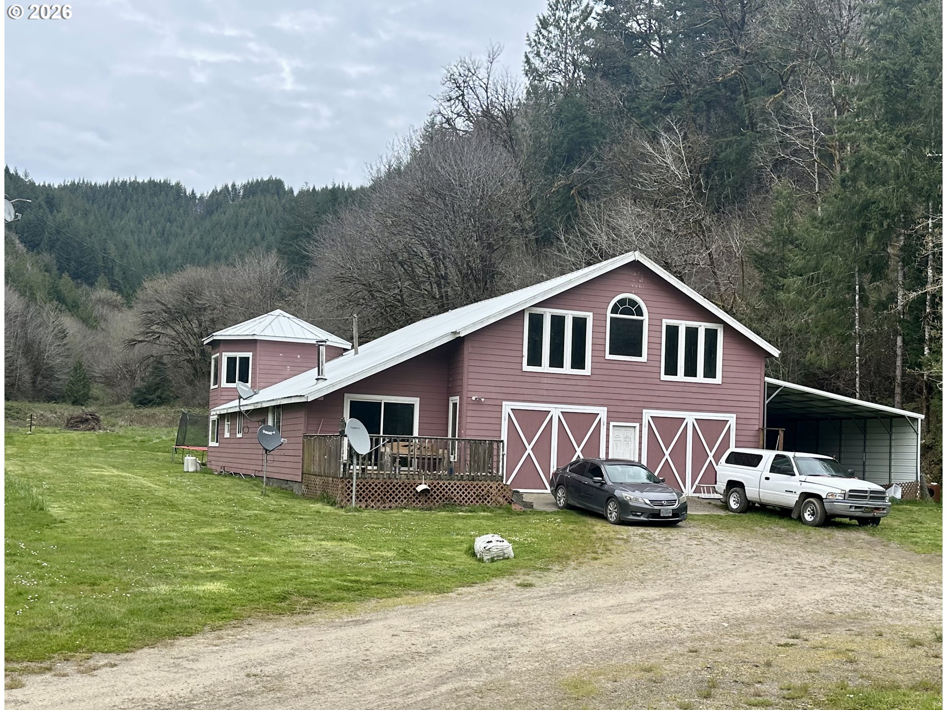 1910 Otter Slough Road Reedsport, OR 97467 - Photo 31 of 39 a front view of a house with a garden and trees