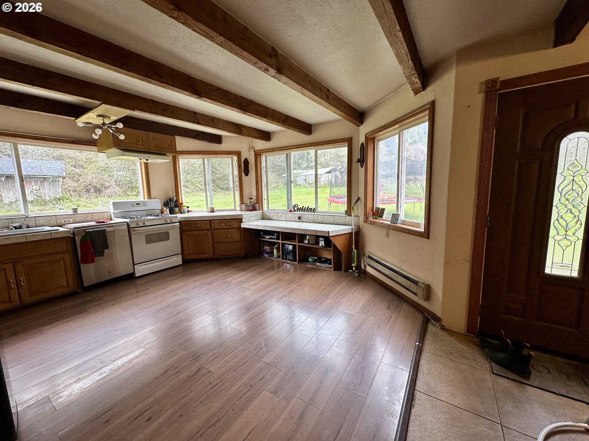 1910 Otter Slough Road Reedsport, OR 97467 - Photo 4 of 39 a room with lots of wooden furniture and stainless steel appliances