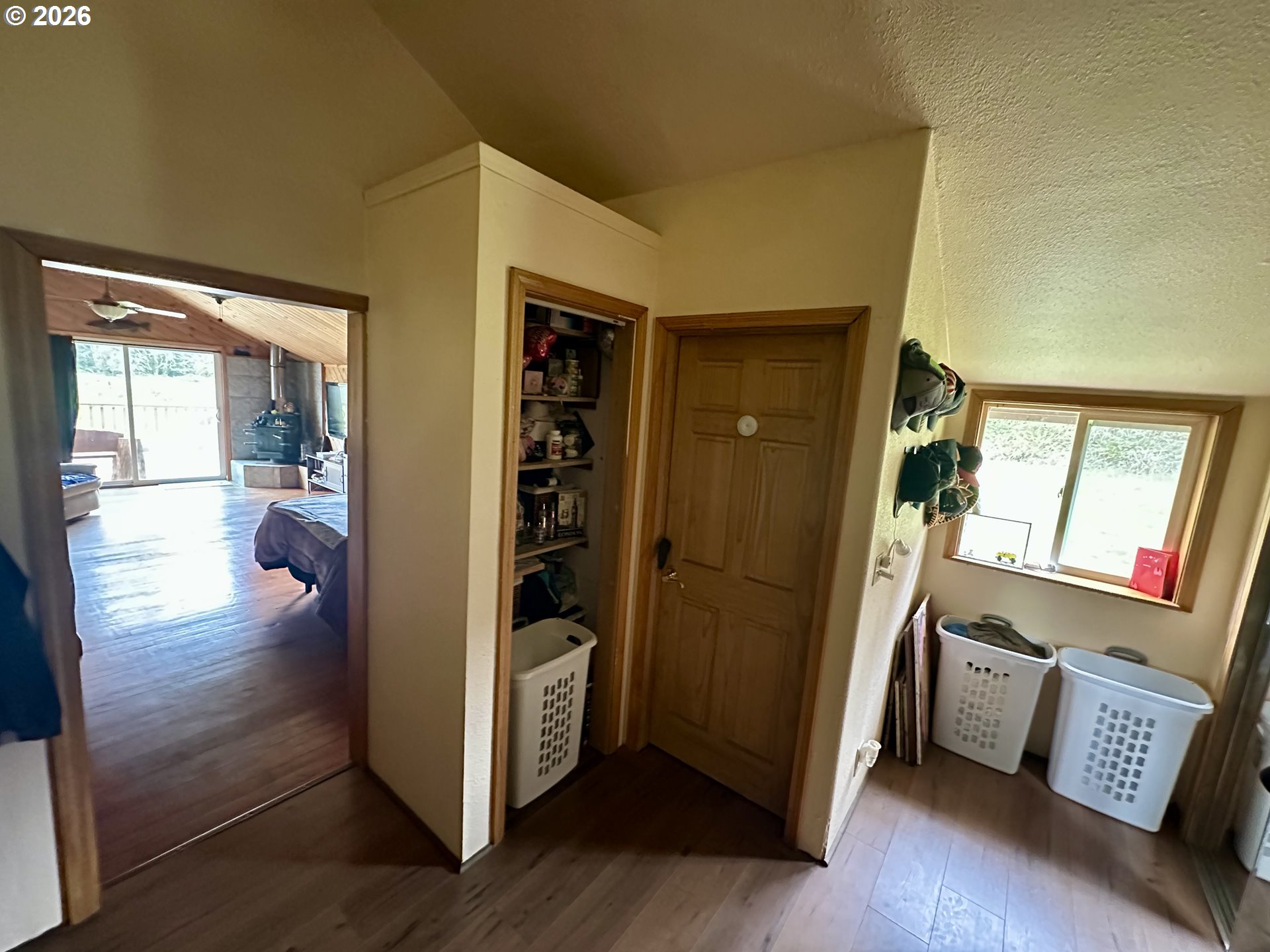 1910 Otter Slough Road Reedsport, OR 97467 - Photo 8 of 39 a view of a hallway and wooden floor and livingroom with furniture