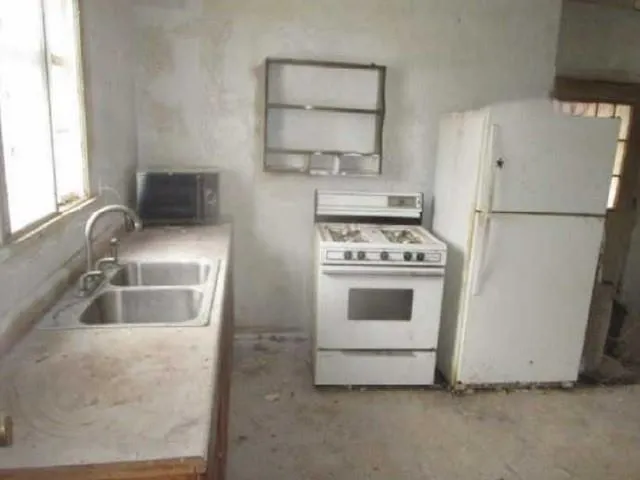 a kitchen with white cabinets and white appliances