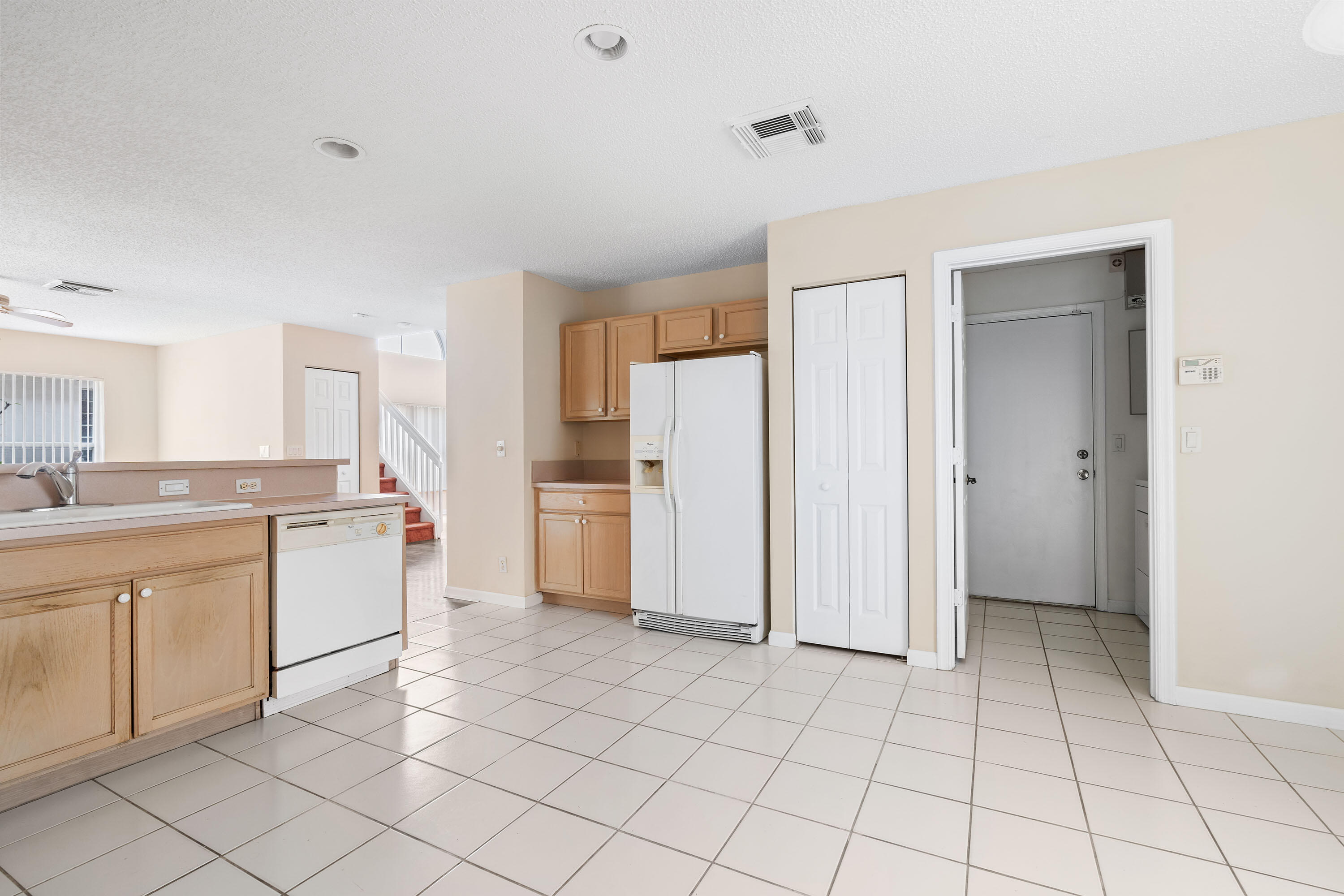 1104 Rialto Drive Boynton Beach, FL 33436 - Photo 11 of 50 a kitchen with white cabinets and white appliances