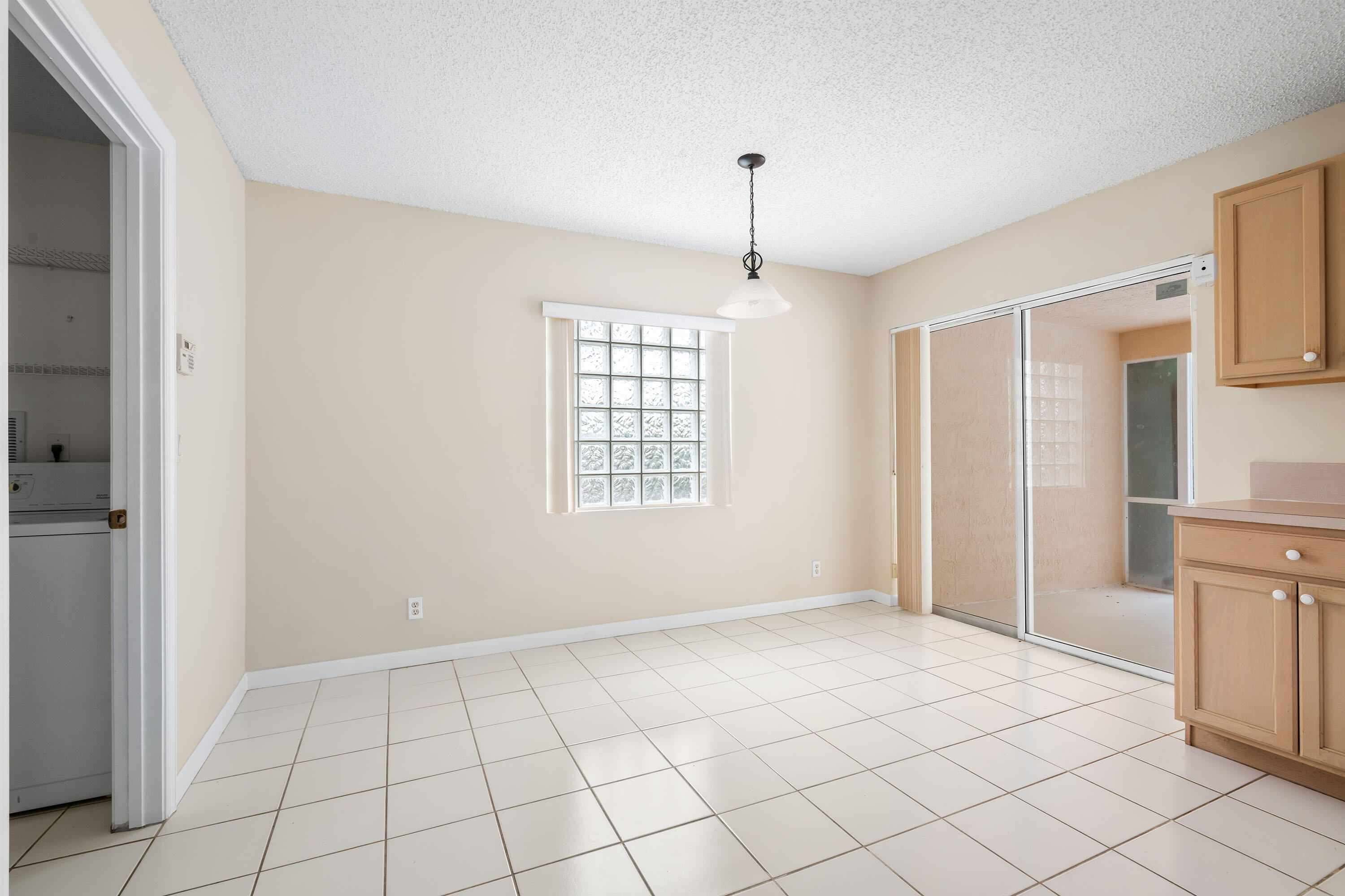 1104 Rialto Drive Boynton Beach, FL 33436 - Photo 12 of 50 a view of an empty room with window and cabinet