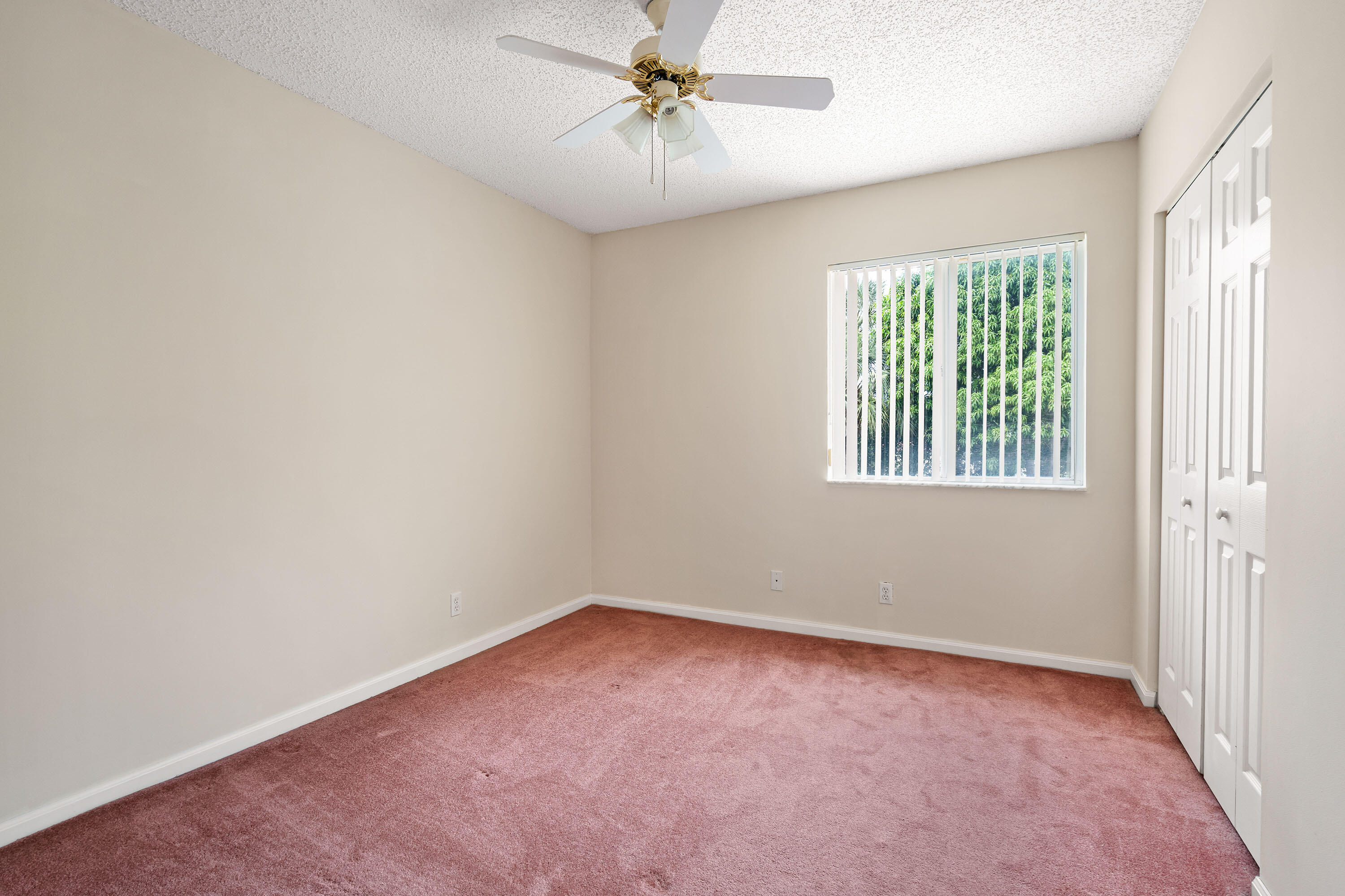 1104 Rialto Drive Boynton Beach, FL 33436 - Photo 17 of 50 an empty room with windows and fan