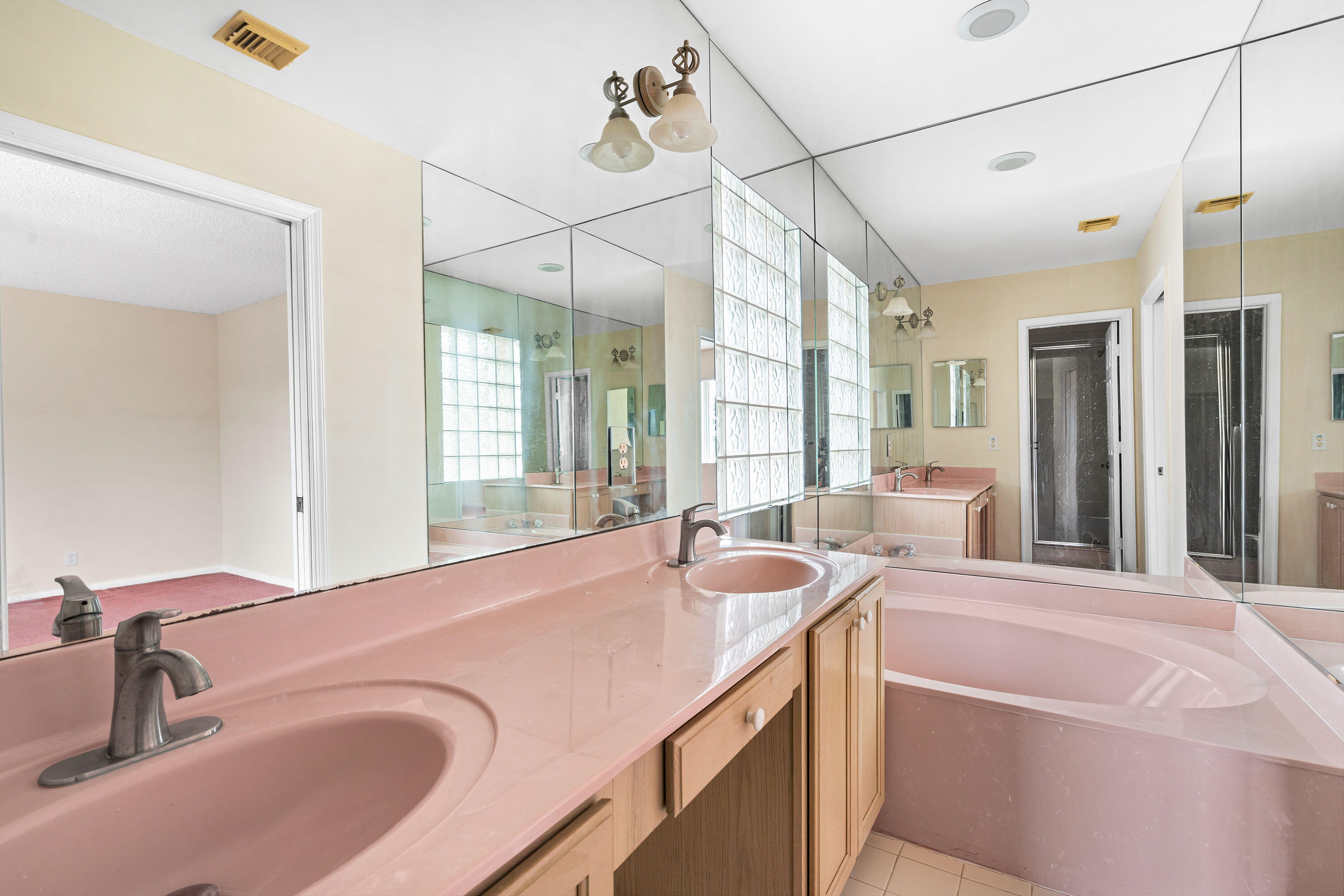 1104 Rialto Drive Boynton Beach, FL 33436 - Photo 24 of 50 a en suite bathroom with a granite countertop sink and a large mirror