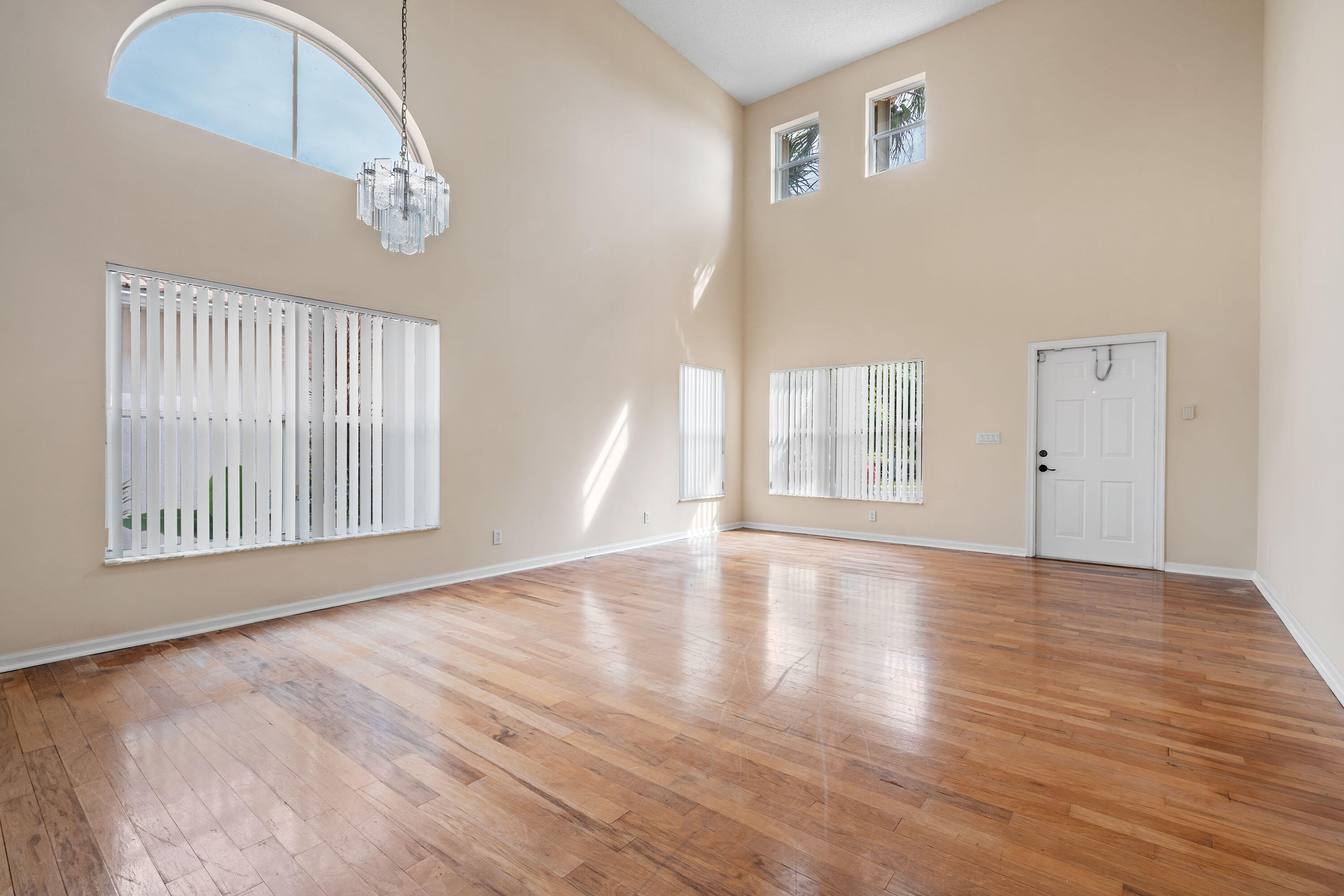 1104 Rialto Drive Boynton Beach, FL 33436 - Photo 3 of 50 a view of an empty room with a window and wooden floor