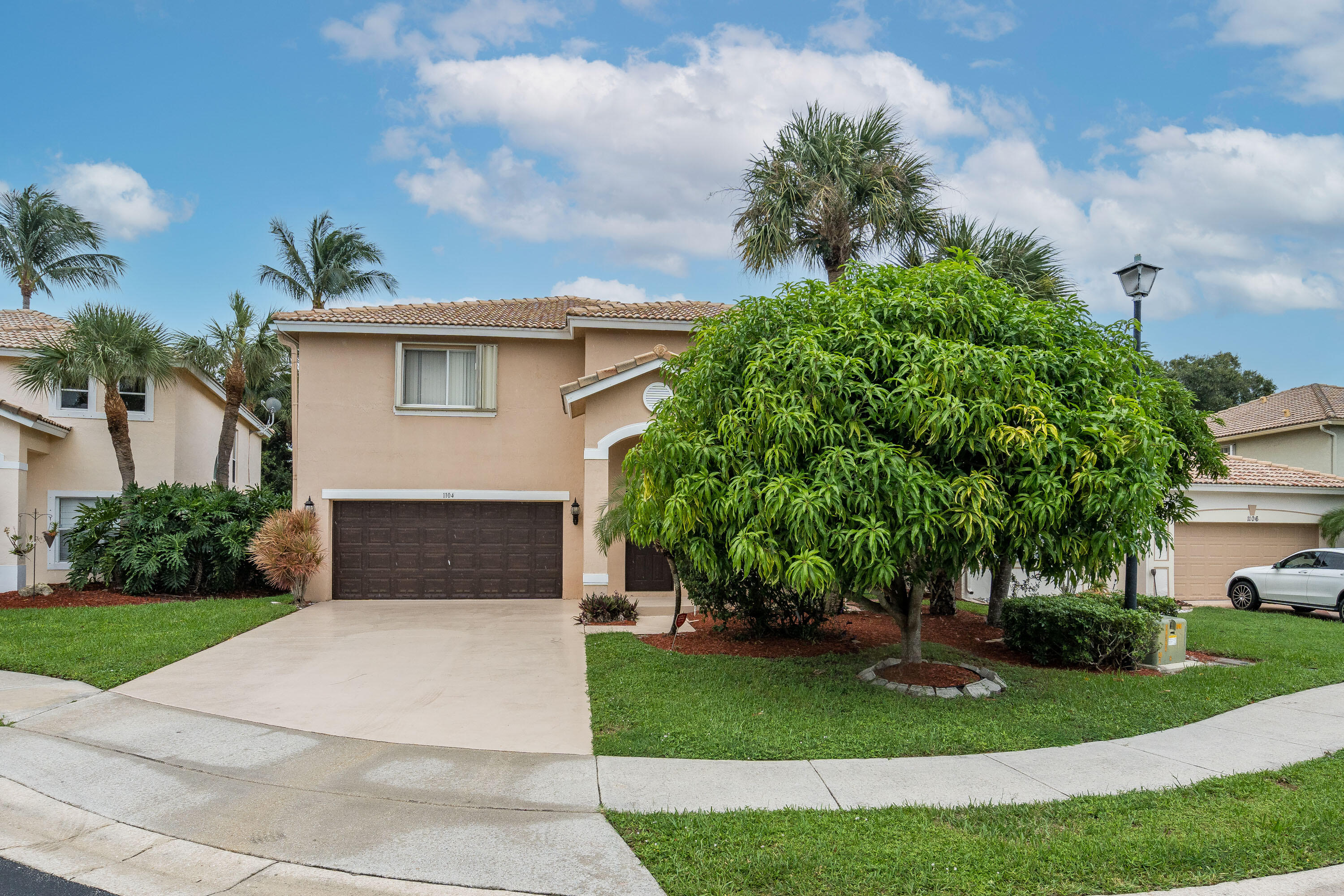1104 Rialto Drive Boynton Beach, FL 33436 - Photo 40 of 50 a front view of a house with a yard and a garage