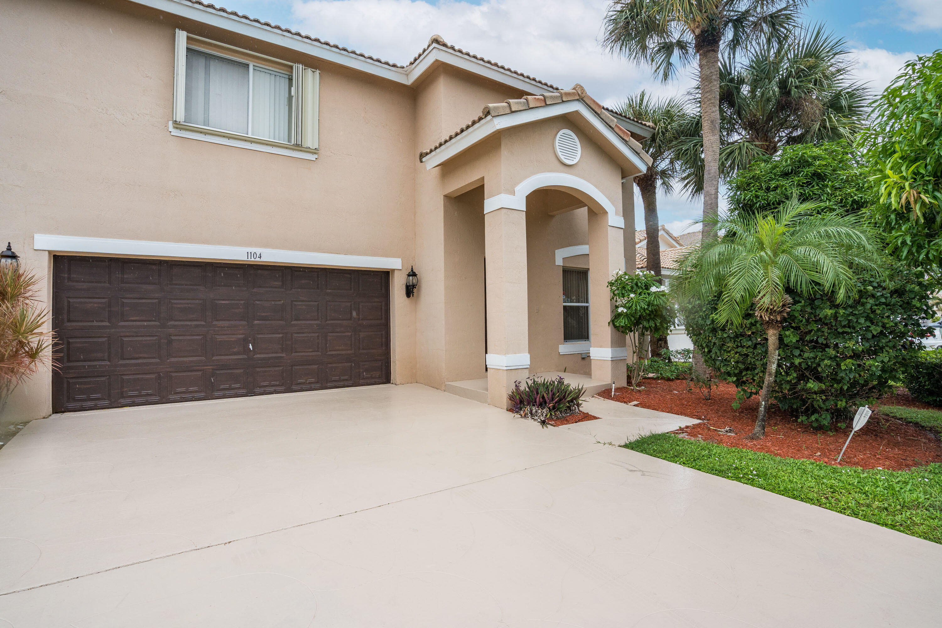 1104 Rialto Drive Boynton Beach, FL 33436 - Photo 41 of 50 a front view of a house with a yard and garage