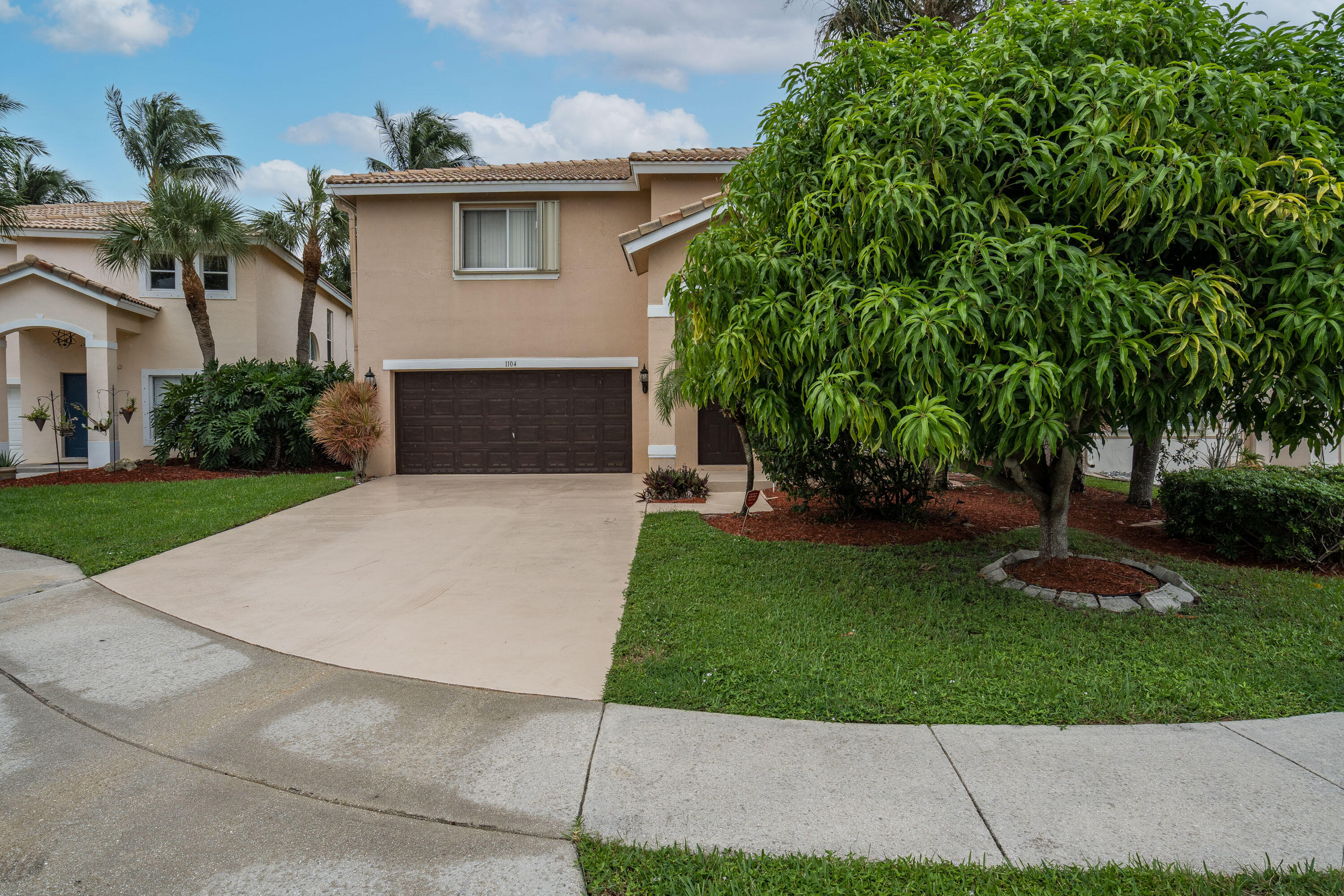 1104 Rialto Drive Boynton Beach, FL 33436 - Photo 44 of 50 a front view of a house with a garden