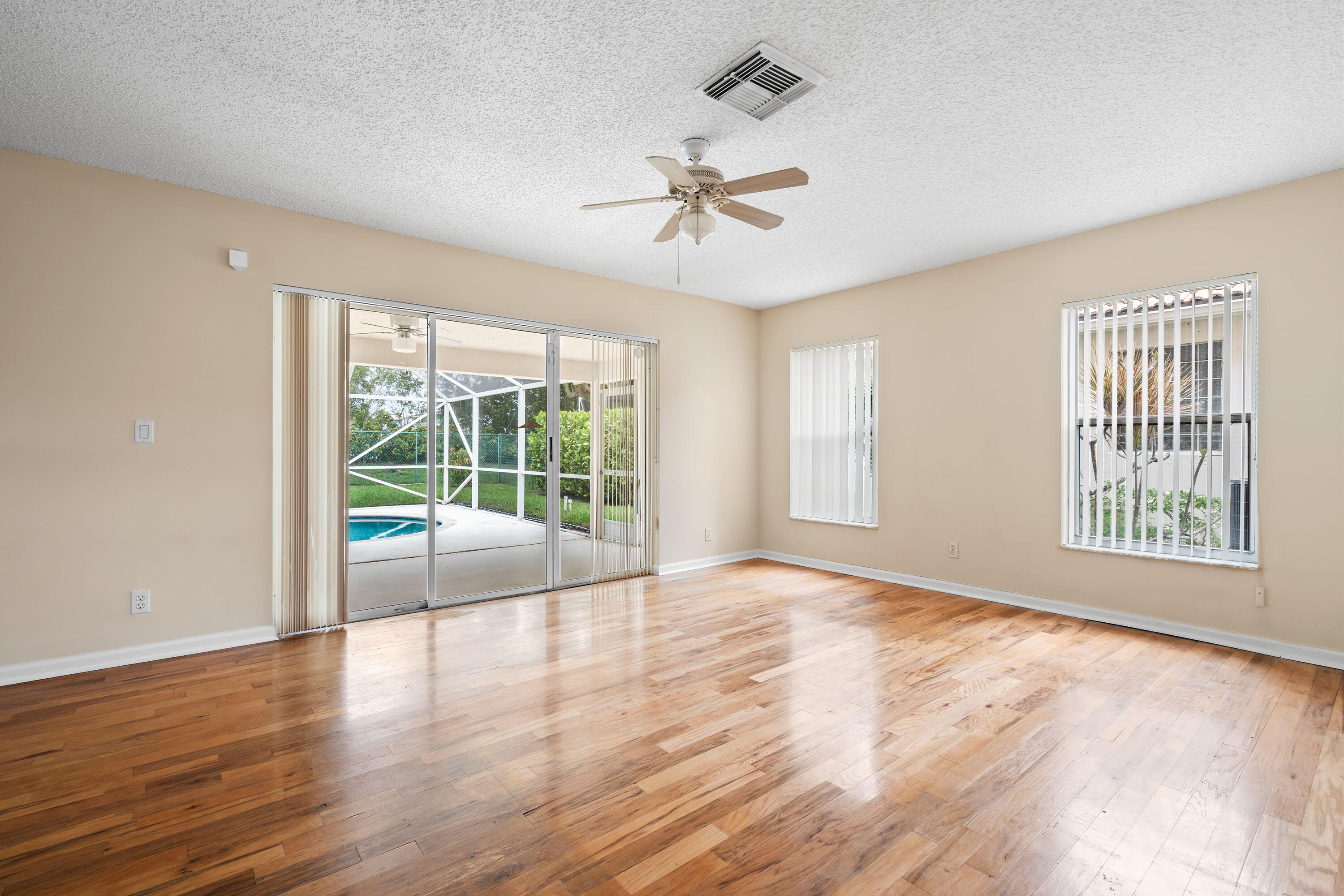 1104 Rialto Drive Boynton Beach, FL 33436 - Photo 5 of 50 a view of an empty room with wooden floor and a window