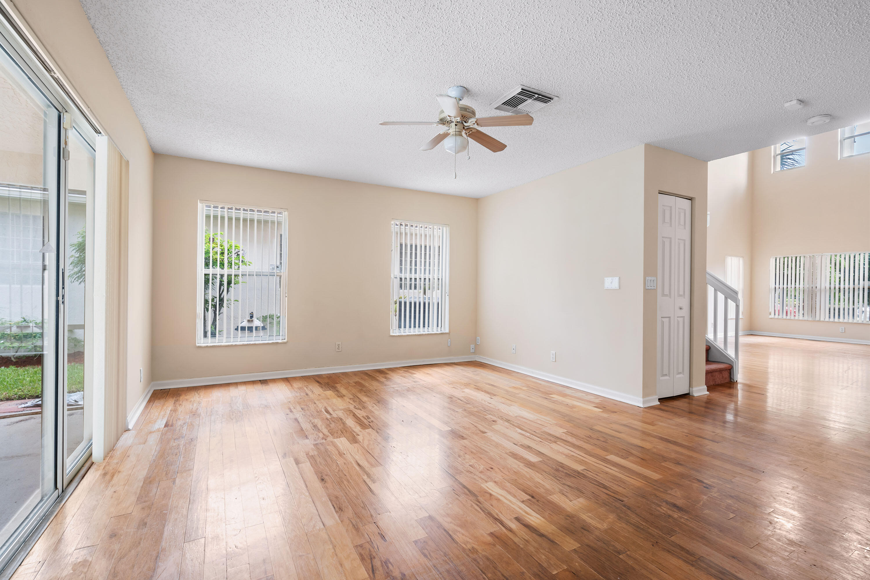 1104 Rialto Drive Boynton Beach, FL 33436 - Photo 6 of 50 a view of an empty room with wooden floor and a window