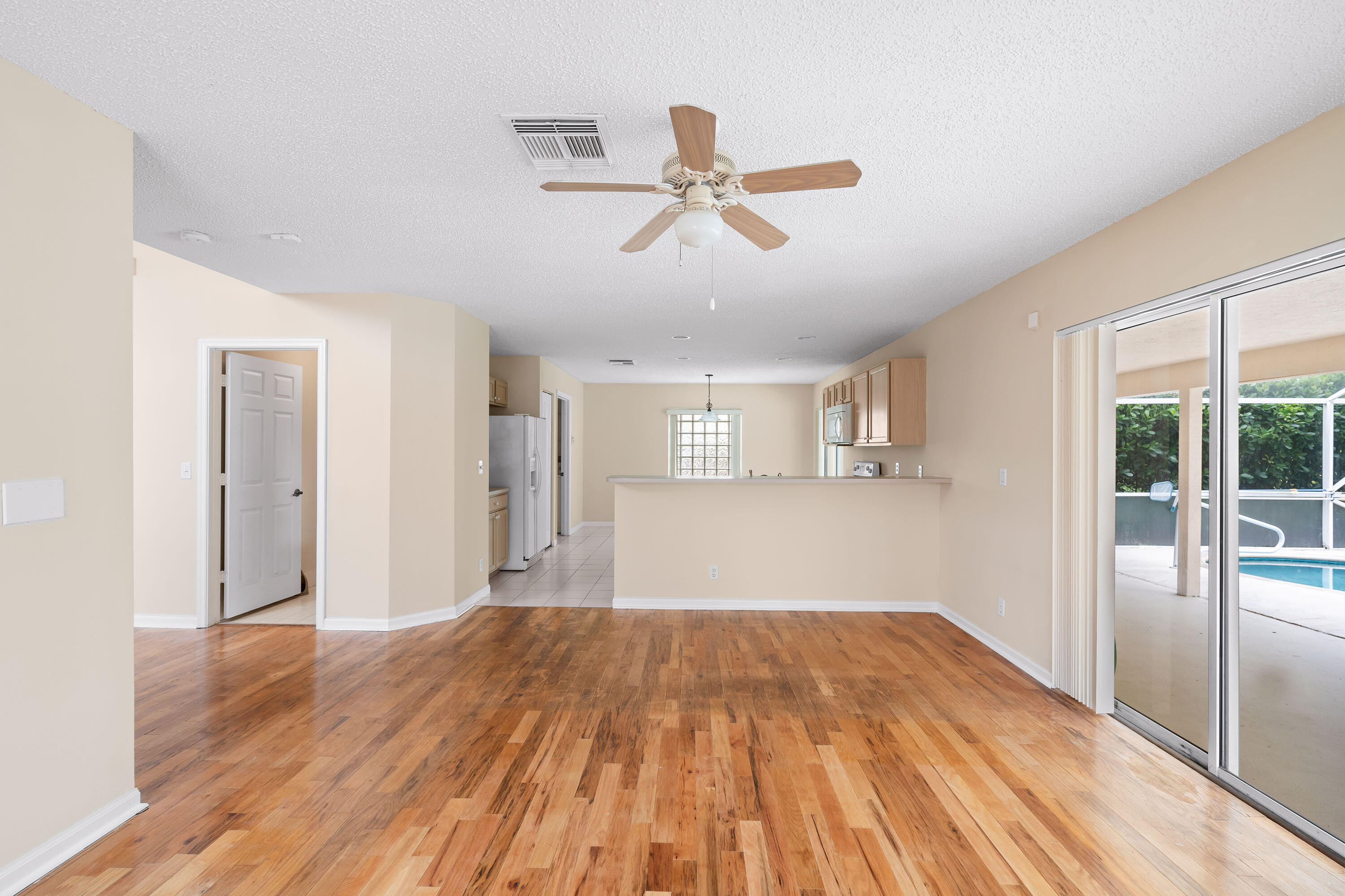 1104 Rialto Drive Boynton Beach, FL 33436 - Photo 7 of 50 a view of empty room with wooden floor and fan