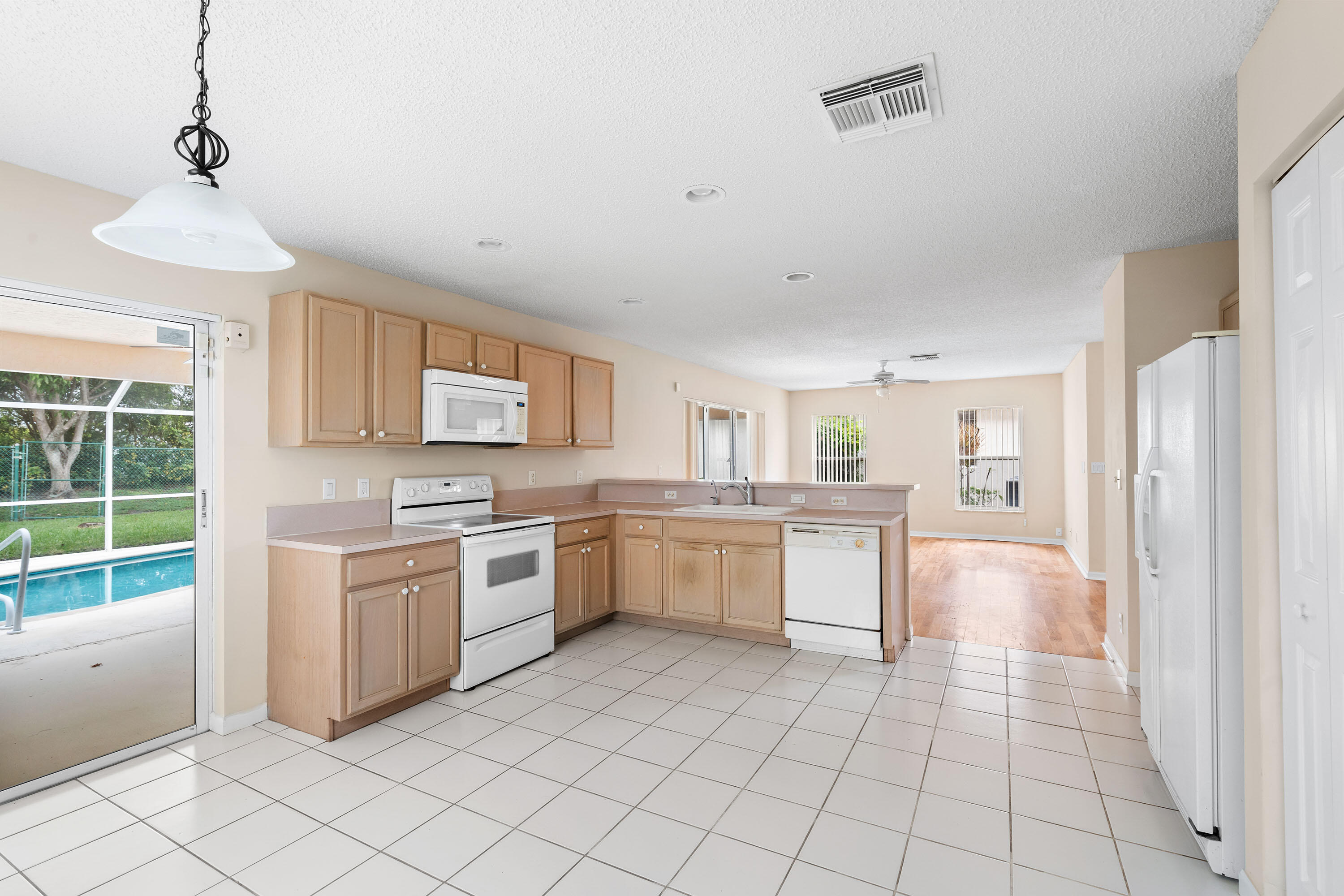 1104 Rialto Drive Boynton Beach, FL 33436 - Photo 10 of 50 a kitchen with a stove top oven sink and cabinets