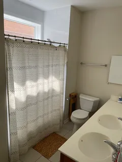 a view of a room with furniture and wooden floor